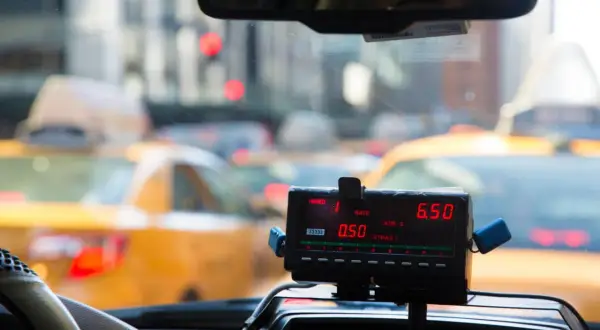 Taksometr w żółtej taksówce pokazuje 6.50. Zastanawiasz się, ile kosztuje taxi za 50 km?